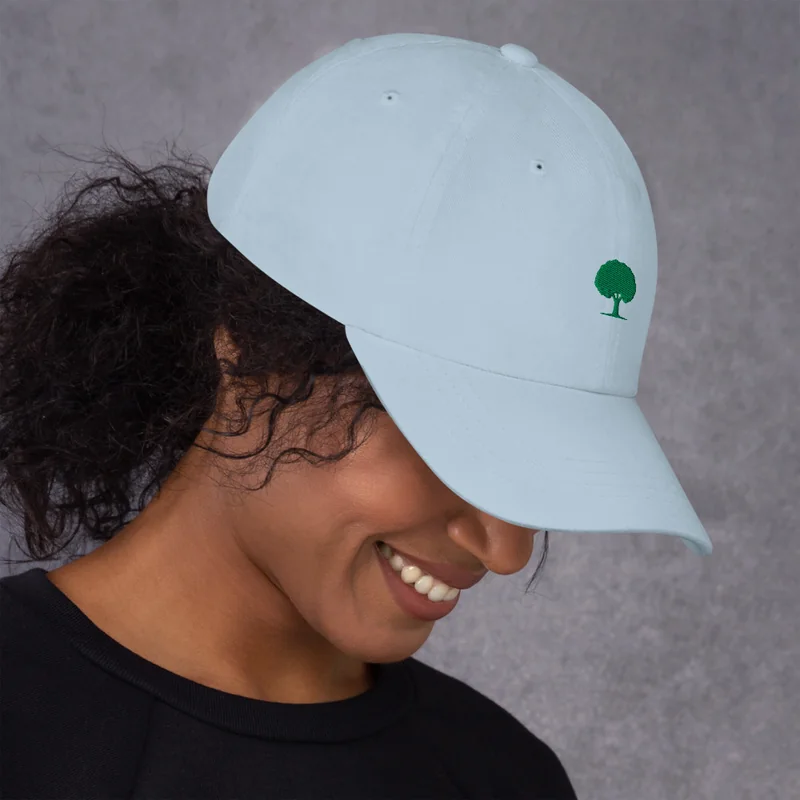 Oak Dad Hat in light blue with a green oak tree stitched on the front, worn by a model